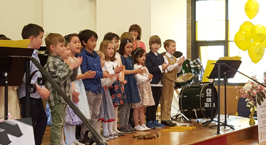 Musica Music School students performing on stage during a voice recital in Toronto