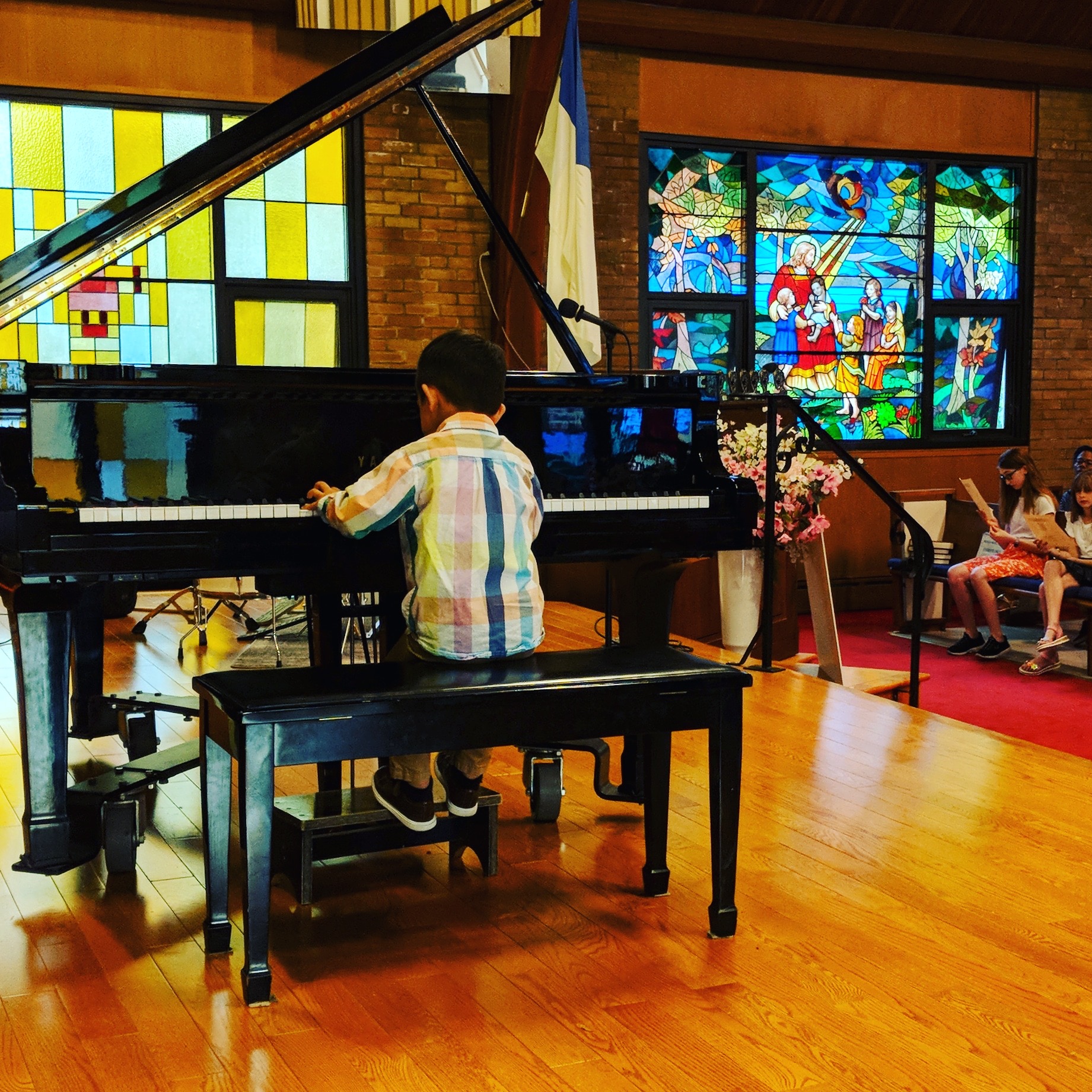 Student performing on stage at the piano during a Musica Music School recital in Toronto